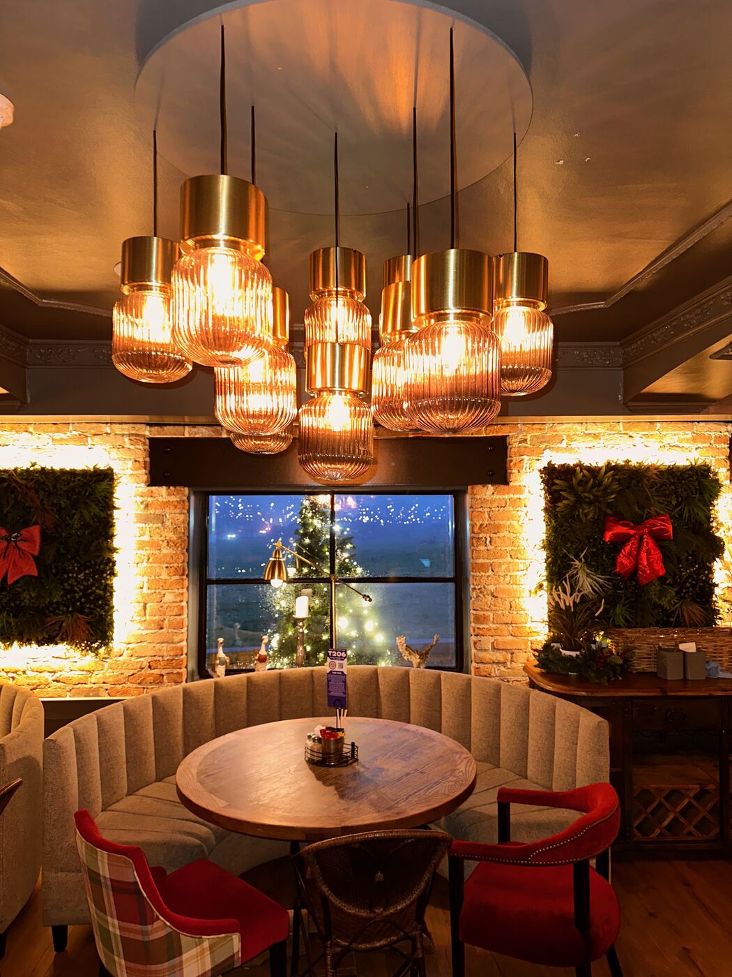 A cosy booth under the gold lights at The Barn, dressed for Christmas