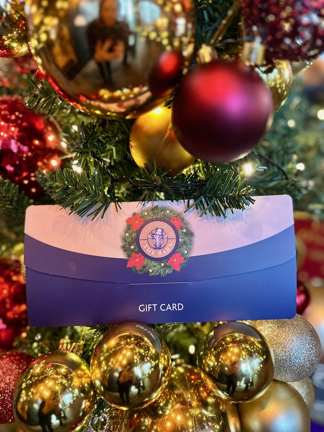 The Barn gift card nestled in a Christmas tree
