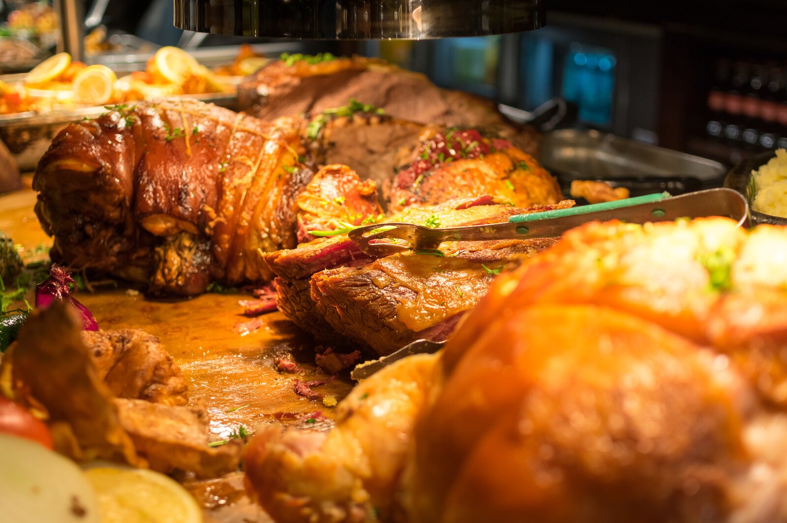 A carvery plate piled with roast, gravy, vegetables and beef-dripping potatoes.