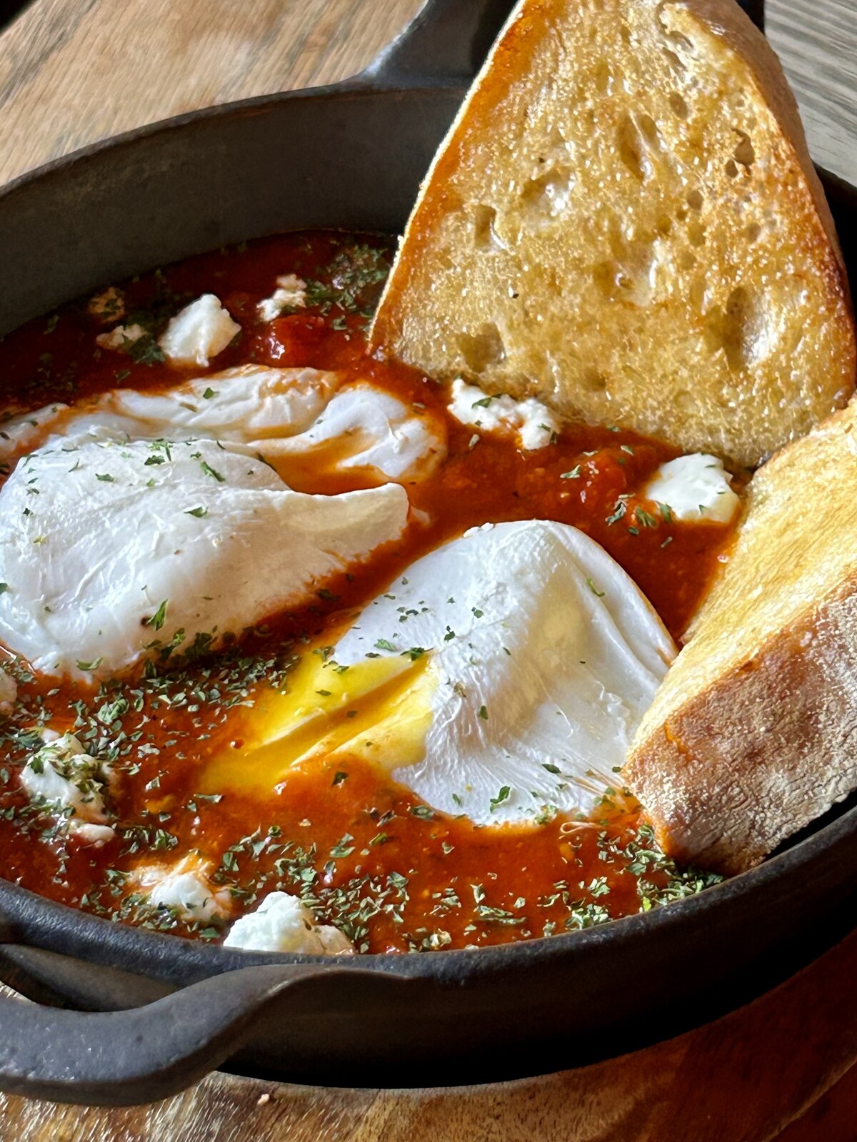 Eggs shakshuka in tomato and pepper sauce.