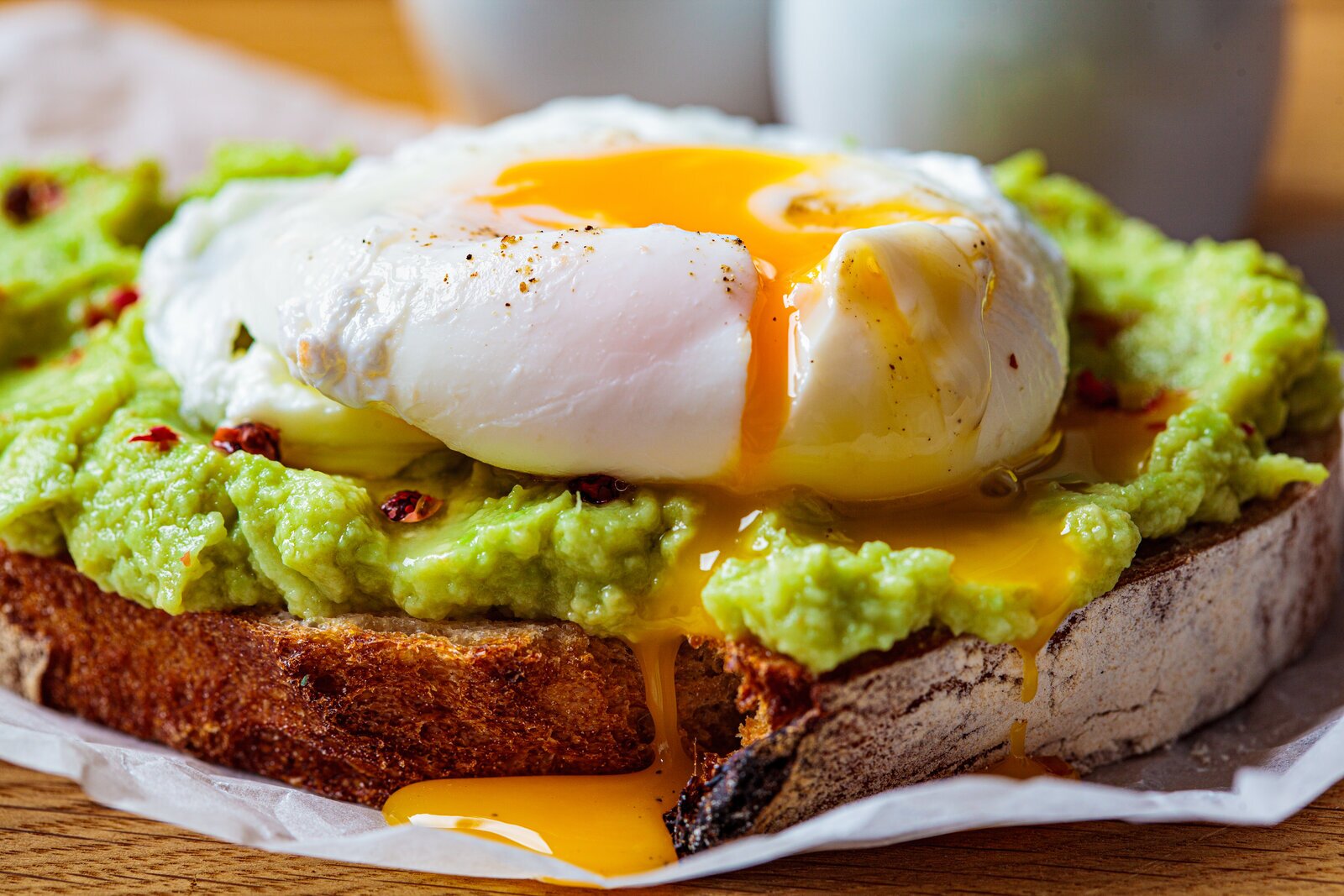 Poached eggs with smashed avocado on toasted sourdough.
